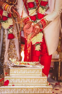 Indian bride and groom throwing the rice together in to fire. Indian bride and groom throwing the rice together in to fire.