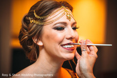 Makeup artist assisting the bride Makeup artist assisting the bride
