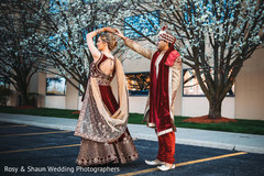 Indian bride and groom dancing for pictures Indian bride and groom dancing for pictures