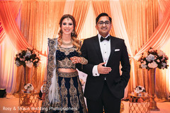 Indian wedding couple ricking their reception outfits Indian wedding couple ricking their reception outfits