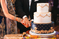 Beautiful indian wedding cake being cut Beautiful indian wedding cake being cut