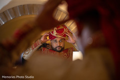 Charming Indian groom putting his turban on. Charming Indian groom putting his turban on.