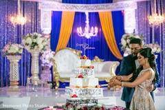 Lovely Indian bride and groom cutting cake together. Lovely Indian bride and groom cutting cake together.
