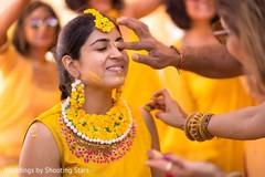 Indian bride getting the turmeric paste on her face. Indian bride getting the turmeric paste on her face.