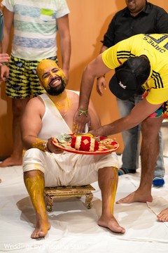 Indian groom being smeared with the turmeric paste. Indian groom being smeared with the turmeric paste.