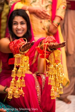 Indian bride with her bracelets with hanging bells . Indian bride with her bracelets with hanging bells .