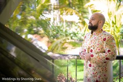 Indian groom putting his sherwani on. Indian groom putting his sherwani on.