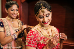 Enchanting Indian bride putting her jewelry on. Enchanting Indian bride putting her jewelry on.