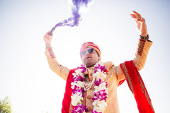 Indian groom pouring purple smoke for his baraat procession. Indian groom pouring purple smoke for his baraat procession.