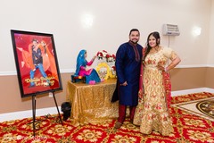 Indian bride and groom posing by the wedding flyer Indian bride and groom posing by the wedding flyer