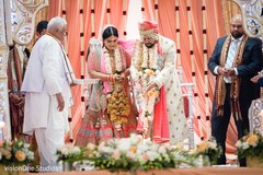 Indian bride and groom under the mandap Indian bride and groom under the mandap