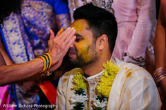 Indian groom getting Turmeric paste on. Indian groom getting Turmeric paste on.