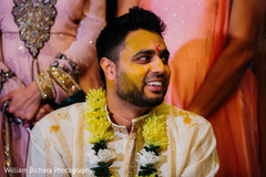 Indian groom getting the turmeric paste on his face. Indian groom getting the turmeric paste on his face.