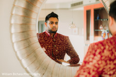 Indian groom getting his sherwani on. Indian groom getting his sherwani on.