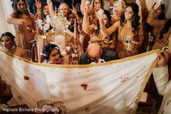 Lovely capture of Indian bridesmaids throwing petals to bride. Lovely capture of Indian bridesmaids throwing petals to bride.