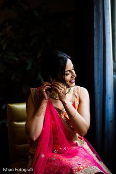 Indian bride getting her earrings on. Indian bride getting her earrings on.