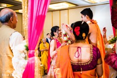 Indian groom putting flower garland to bride. Indian groom putting flower garland to bride.