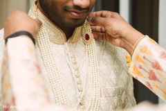 Indian groom putting his kundan mala . Indian groom putting his kundan mala .