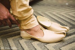 Indian groom putting his ceremony shoes on. Indian groom putting his ceremony shoes on.