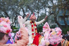 Indian groom on his baraat white horse celebrating. Indian groom on his baraat white horse celebrating.