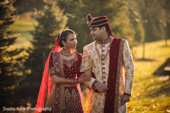 Indian bride and groom posing with their ceremony outfits. Indian bride and groom posing with their ceremony outfits.