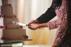 Indian wedding reception cutting the cake scene Indian wedding reception cutting the cake scene