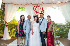 Indian newlyweds posing with family Indian newlyweds posing with family