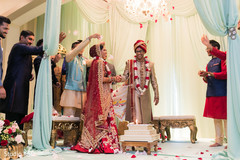 Indian couple being trowed rose petals. Indian couple being trowed rose petals.