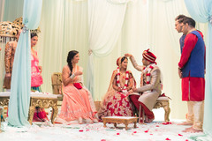 Indian groom putting the red dot to bride. Indian groom putting the red dot to bride.
