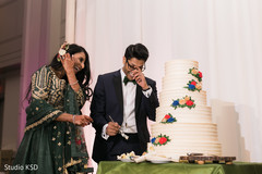 Lovely capture Indian bride and groom cutting cake together. Lovely capture Indian bride and groom cutting cake together.