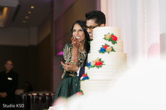 Maharani taking a cake bite. Maharani taking a cake bite.