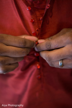 Closeup capture of Indian groom putting on his sangeet sherwani. Closeup capture of Indian groom putting on his sangeet sherwani.