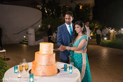 Lovely capture Indian bride and groom cutting cake together. Lovely capture Indian bride and groom cutting cake together.