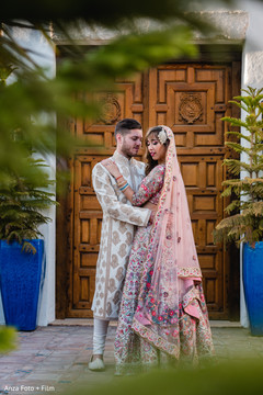 Indian bride and groom posing outdoors Indian bride and groom posing outdoors