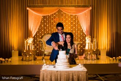 Lovely Indian bride and groom cutting cake together. Lovely Indian bride and groom cutting cake together.