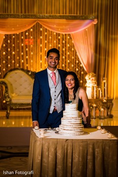 Lovely indian couple cutting the cake. Lovely indian couple cutting the cake.