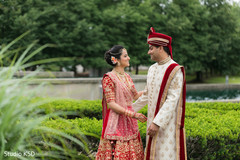Indian bride and groom outdoors taking pictures Indian bride and groom outdoors taking pictures