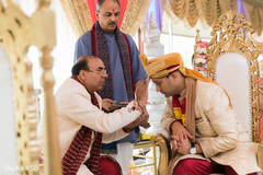 Red mark applied on Indian groom's forehead. Red mark applied on Indian groom's forehead.