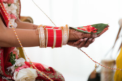 Maharani holding flower petals and rice on leaf. Maharani holding flower petals and rice on leaf.