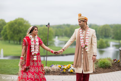 Dazzling Indian bride and groom walking holding hands. Dazzling Indian bride and groom walking holding hands.