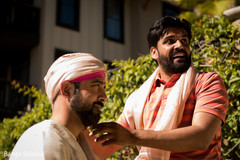 Indian groom being assisted by special guest Indian groom being assisted by special guest
