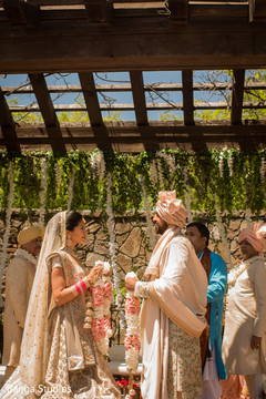 Indian bride and groom at their jaimala ritual. Indian bride and groom at their jaimala ritual.