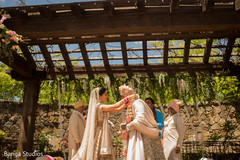 Indian bride putting garland to groom. Indian bride putting garland to groom.