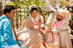 Indian couple pouring rice to sacred fire ritual. Indian couple pouring rice to sacred fire ritual.