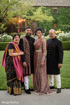 Indian Couple posing with relatives on their reception outfits. Indian Couple posing with relatives on their reception outfits.