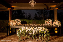 Indian wedding wood table with candles and flowers decorations. Indian wedding wood table with candles and flowers decorations.