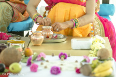 Indian bride preparing the items for the haldi rituals. Indian bride preparing the items for the haldi rituals.