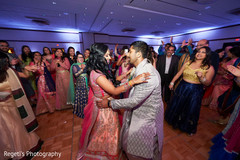 Indian bride and groom dancing during sangeet Indian bride and groom dancing during sangeet