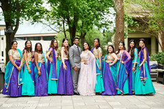 Glamorous Indian couple posing with bridesmaids. Glamorous Indian couple posing with bridesmaids.