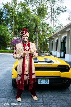 Charming groom posing with his wedding vehicle. Charming groom posing with his wedding vehicle.
